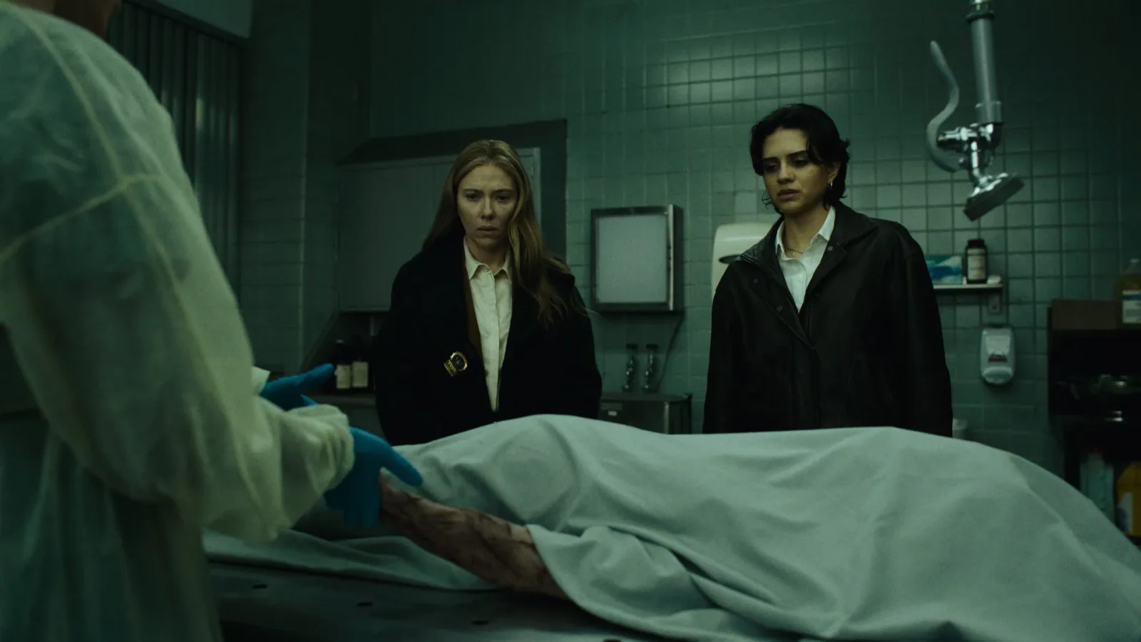 Scarlett Johansson and Sasha Calle as NYPD homicide detectives Julie Miller and Gina Restrepo in a morgue in The Exorcist: Martyrs